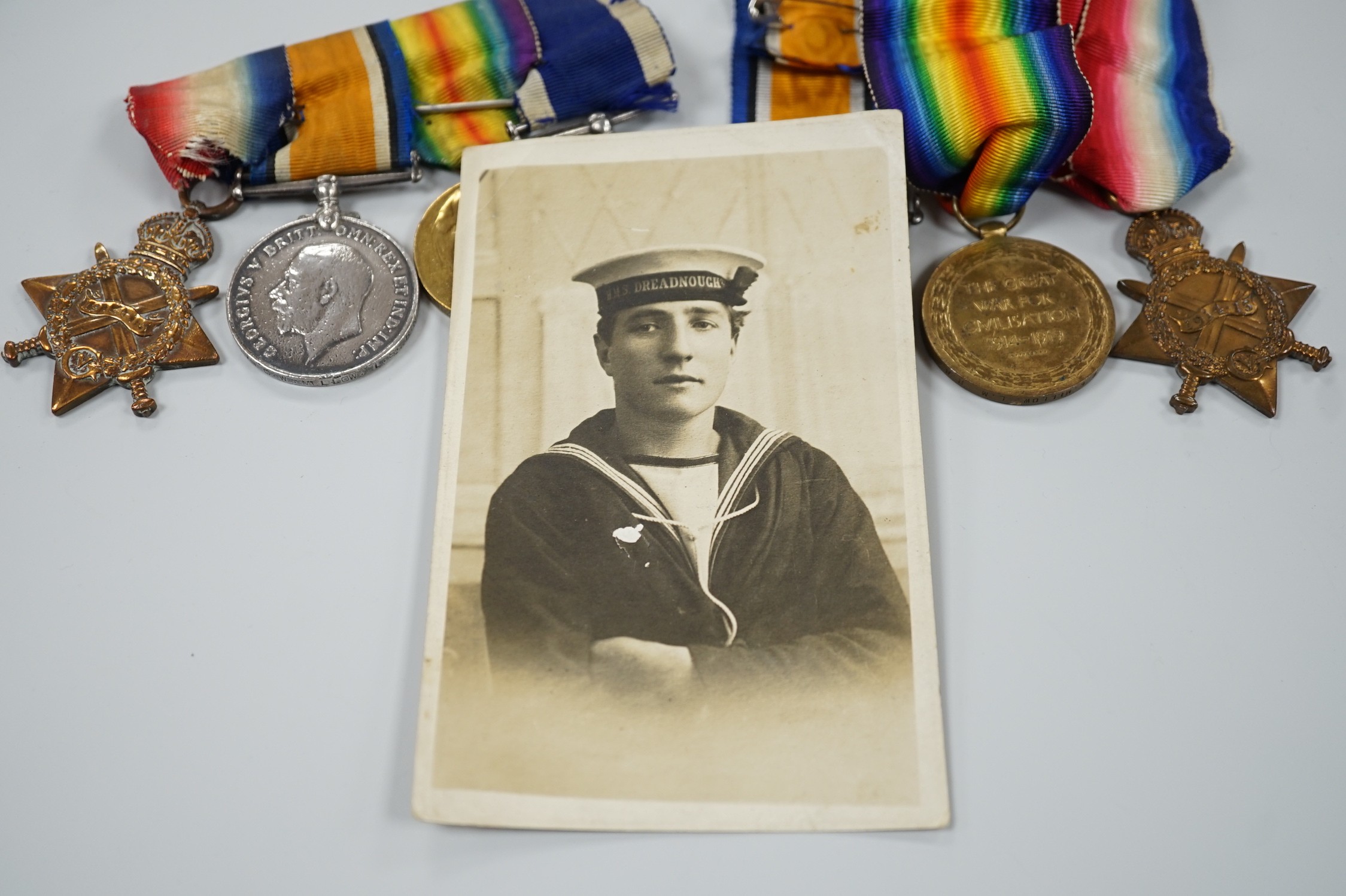 A WWI naval medal group of four with portrait photo with records and one other WWI trio